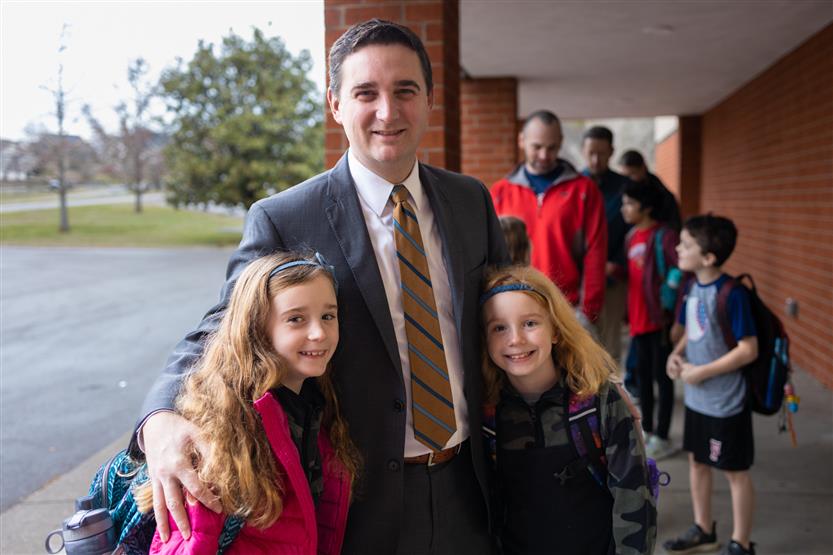 Students and their families enjoy donuts